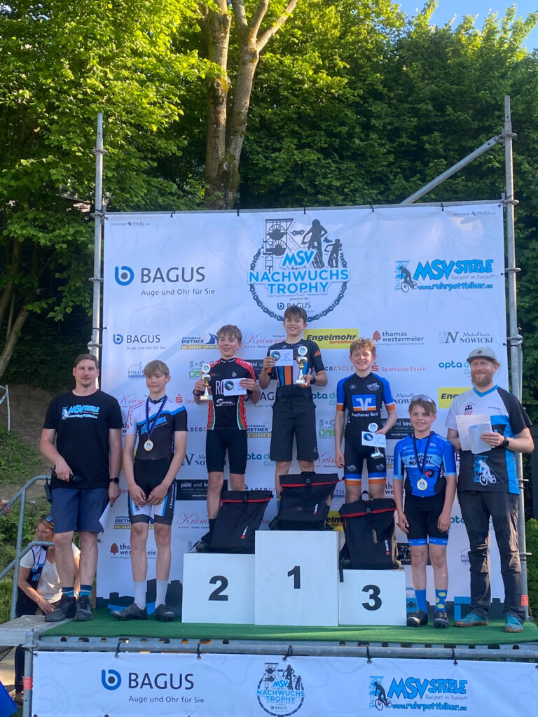 Jugendliche stehen auf einem Podium bei einer Siegerehrung.