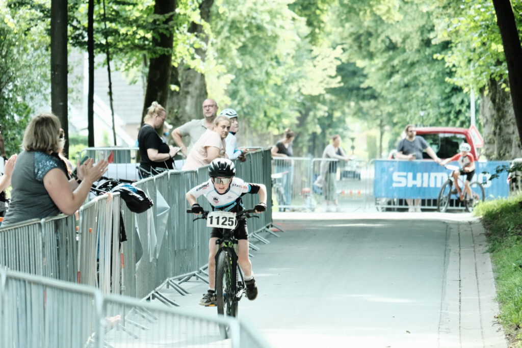 Kinder Fahren bei einem Mountainbikerennen.