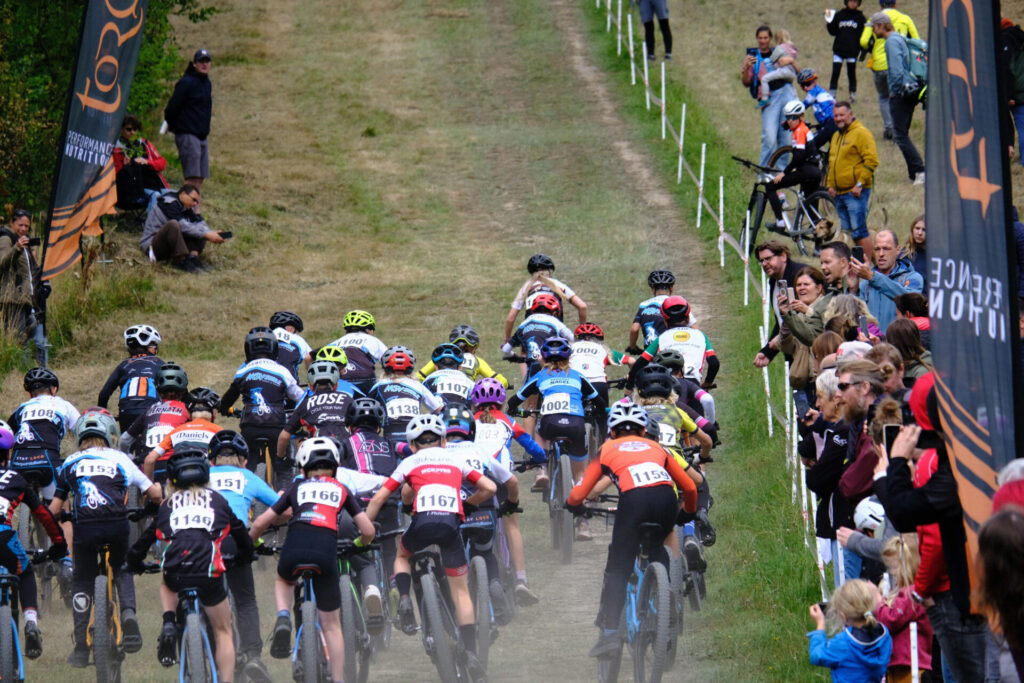 Kinder und Jugendliche Fahren bei einem MTB-Rennen.